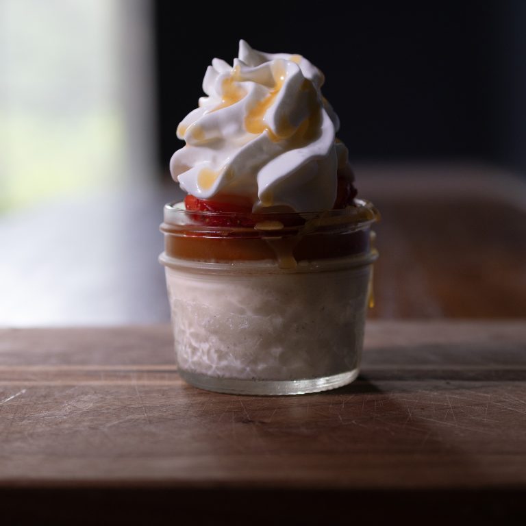 Northern Italian Panna Cotta with macerated strawberries, salted caramel, and whipped cream