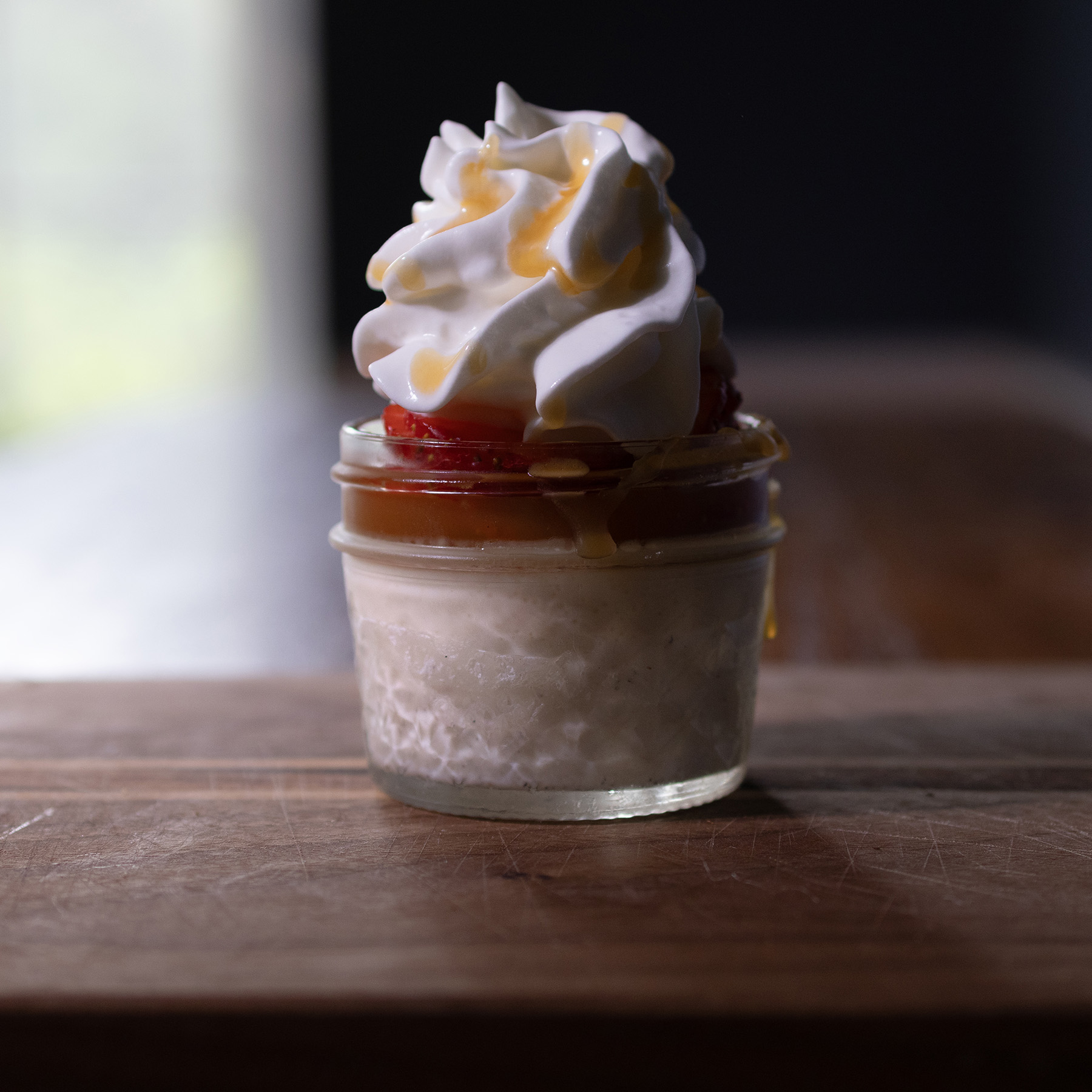 Northern Italian Panna Cotta with macerated strawberries, salted caramel, and whipped cream