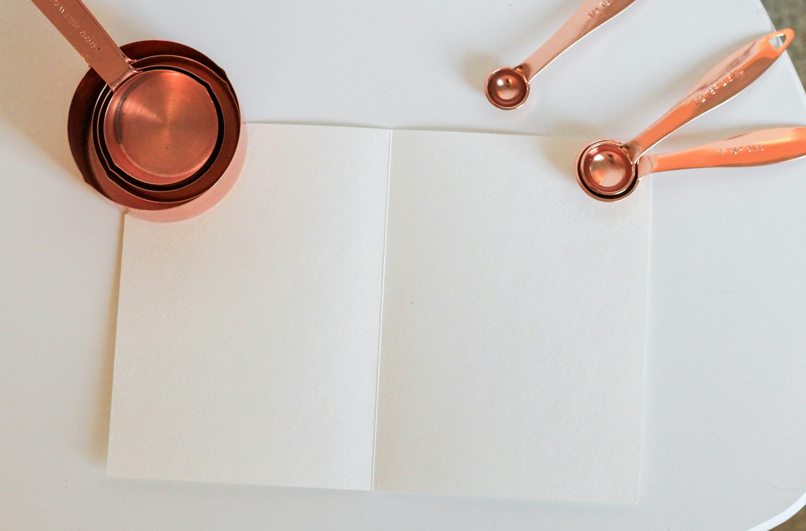 Measuring cup on white paper