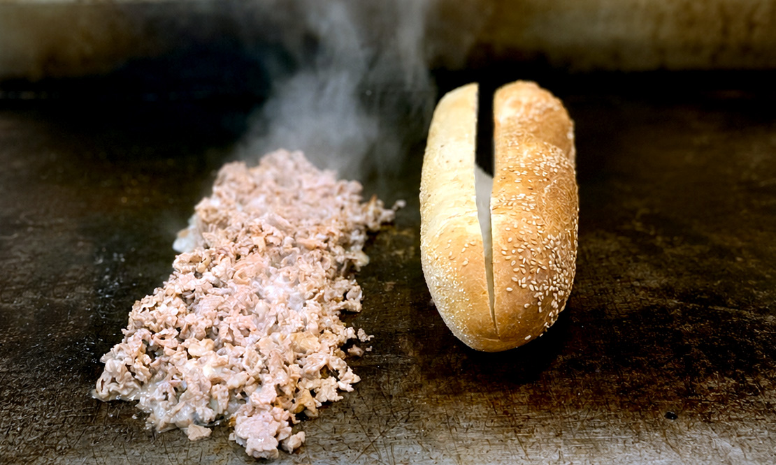 Cheesesteak cooking on the grill